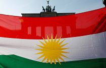 Protesters hold a Kurdish flag during a rally against the Turkish military operation in Syria, in Berlin, Germany, October 14, 2019