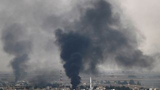 Smoke rises over the Syrian town of Ras al Ain, as seen from the Turkish border town of Ceylanpinar