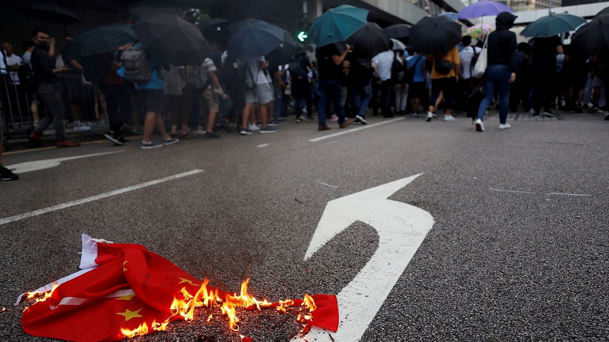 A Chinese flag burns as anti-government protesters block a street in Central Hong Kong, China October 4, 2019