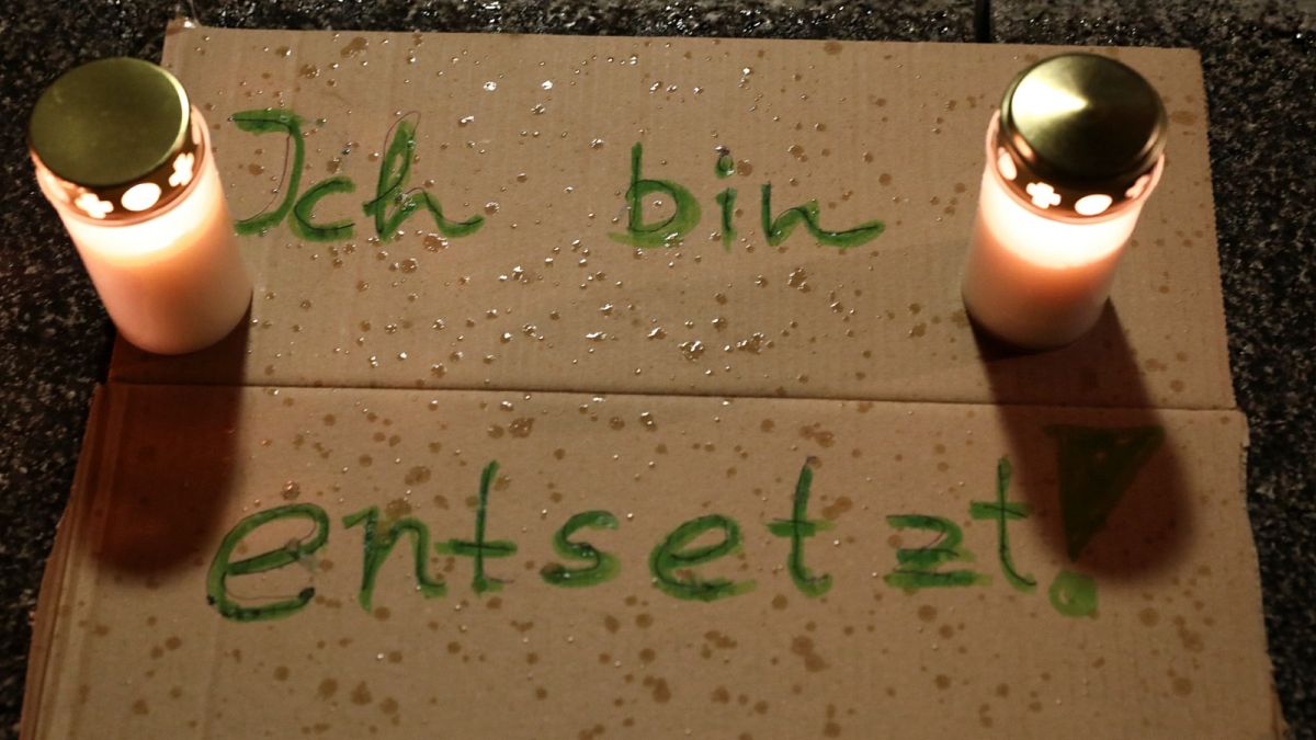 Lit candles are seen with a sign reading "I am horrified" during a gathering at the New Synagogue in Berlin, after two people were killed in a shooting in the city of Halle