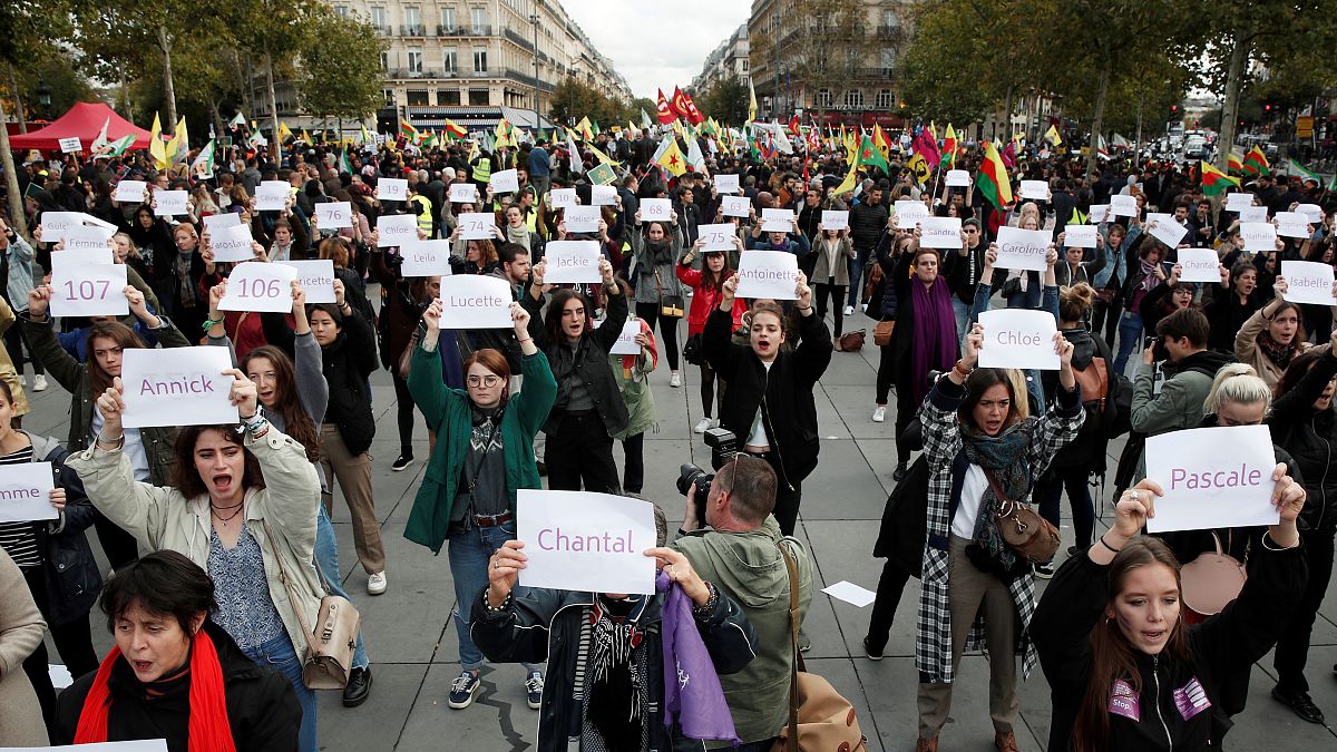 People attend a demonstration against femicide and violence against women at Place de la Republique in Paris