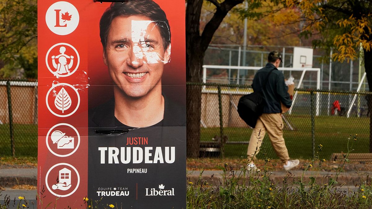 A man walks past a Justin Trudeau sign in the Papineau area of Montreal, Quebec, Canada October 20, 2019. 