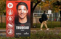 A man walks past a Justin Trudeau sign in the Papineau area of Montreal, Quebec, Canada October 20, 2019.