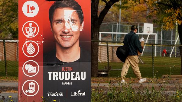 A man walks past a Justin Trudeau sign in the Papineau area of Montreal, Quebec, Canada October 20, 2019. A man walks past a Justin Trudeau sign in the Papineau area of Montreal, Quebec, Canada October 20, 2019.
