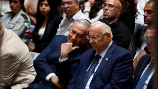 Israeli Prime Minister Benjamin Netanyahu chats with Israeli President Reuven Rivlin during a memorial ceremony for Israeli soldiers killed in the 1973 Middle East War