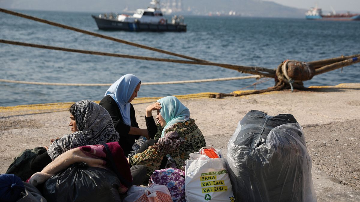 Refugees and migrants wait to be transferred to camps on the mainland, at the port of Elefsina near Athens Greece, October 22, 2019. 