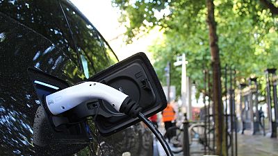 An electric car charges at a roadside charging point An electric car charges at a roadside charging point
