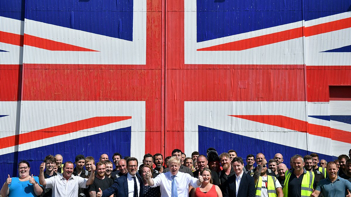 Conservative leadership candidate Boris Johnson poses for a photograph with workers at the Wight Shipyard Company at Venture Quay during a visit to the Isle of Wight, Britain 