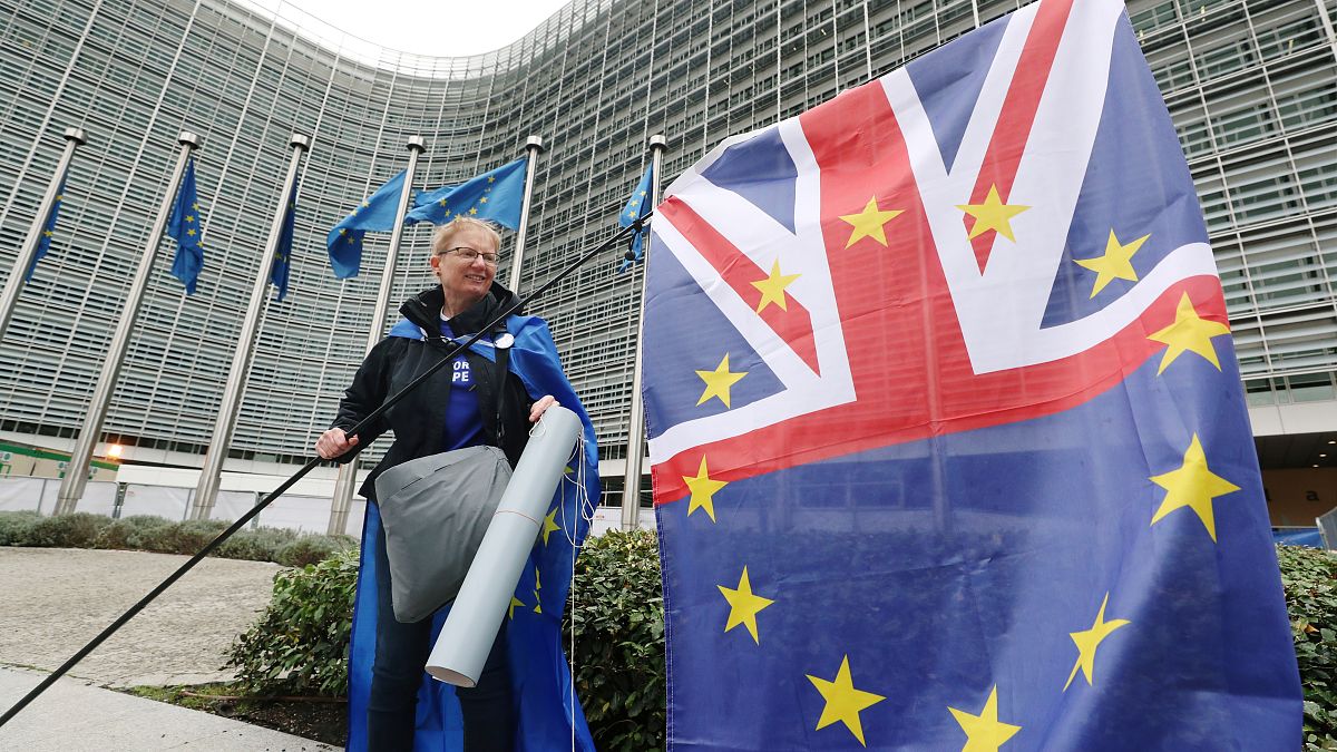 A woman holds a flag during a protest against Brexit outside the EU Commission headquarters in Brussels, Belgium October 9, 2019.