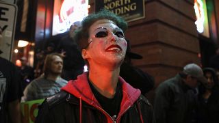 A counter protester wears a "Joker" mask after a rally by U.S. President Donald Trump in Minneapolis