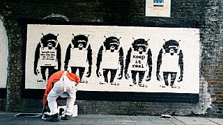 A picture, supposedly of elusive British artist Banksy at work 