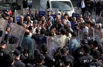 Pro-Kurdish Peoples' Democratic Party (HDP) lawmakers are surrounded by riot police as they protest against detention of their local politicians in Diyarbakir, Turkey
