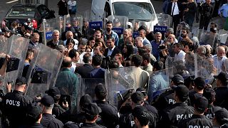 Pro-Kurdish Peoples' Democratic Party (HDP) lawmakers are surrounded by riot police as they protest against detention of their local politicians in Diyarbakir, Turkey