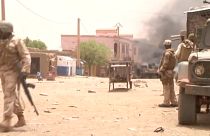 FILE:  Soldiers stand guard as smoke rises in the distance after a car bomb attack in Gao, northern Mali July 1, 2018. 