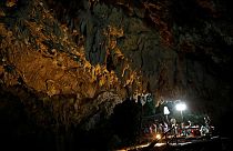 Journalists work in Tham Luang caves during a search for 12 members of an under-16 soccer team and their coach, in the northern province of Chiang Rai