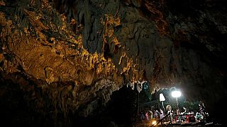Journalists work in Tham Luang caves during a search for 12 members of an under-16 soccer team and their coach, in the northern province of Chiang Rai