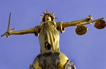 A statue over the Old Bailey court in central London.