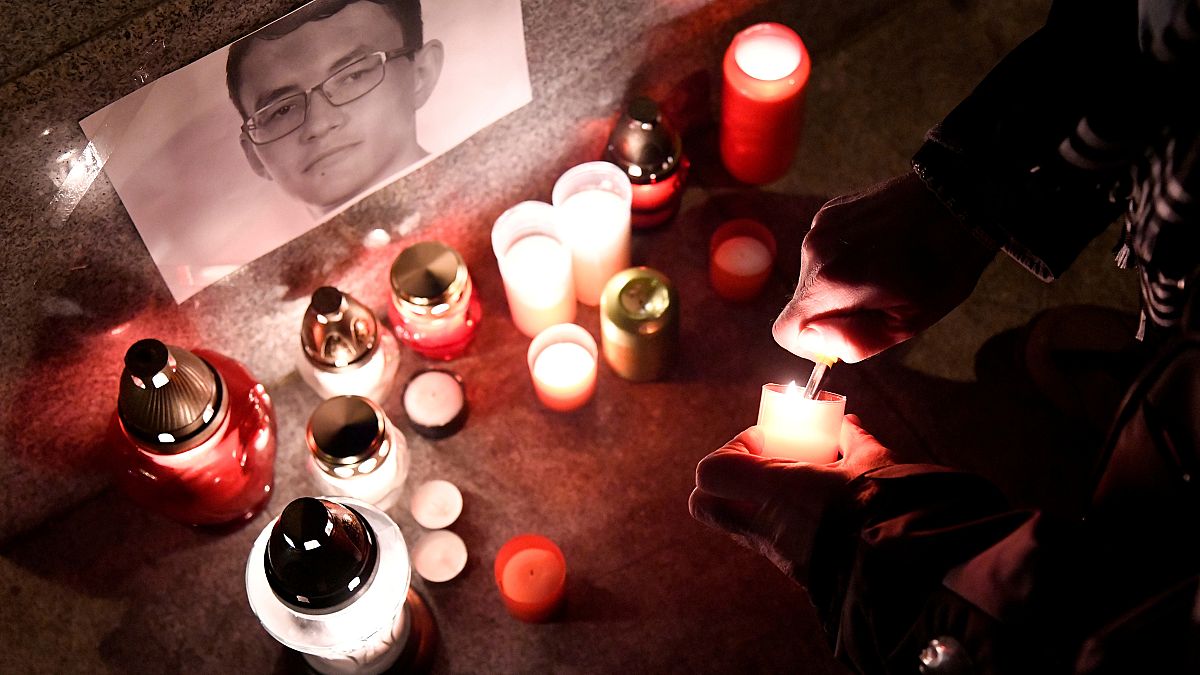 A journalist lights a candle in memory of murdered investigative journalist Jan Kuciak, in Trencin, Slovakia, February 26, 2018. 