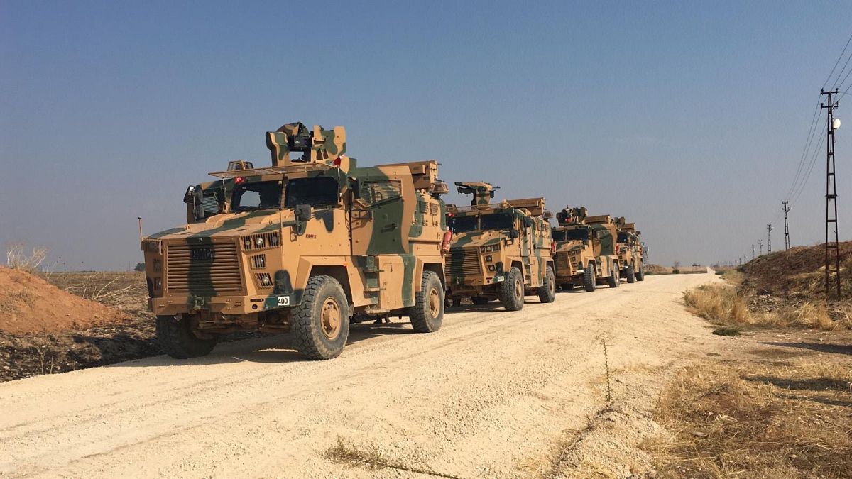 Turkish military vehicles are seen on the Turkish-Syrian border before a joint Turkish-Russian patrol in northeast Syria.