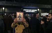 A woman holds a religious icon as she protests against the screening of "And Then We Danced", a Georgian movie about gay love in Tbilisi, Georgia