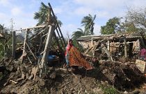 A woman cleans her house damaged by Cyclone Bulbul in Bakkhali on November 10, 2019