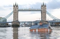 Extinction Rebellion floats British house mock-up "sinking" in Thames in climate protest