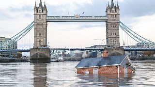 Extinction Rebellion floats British house mock-up "sinking" in Thames in climate protest