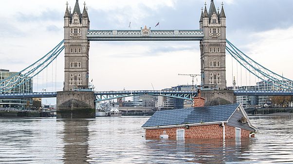 Extinction Rebellion floats British house mock-up "sinking" in Thames in climate protest Extinction Rebellion floats British house mock-up "sinking" in Thames in climate protest