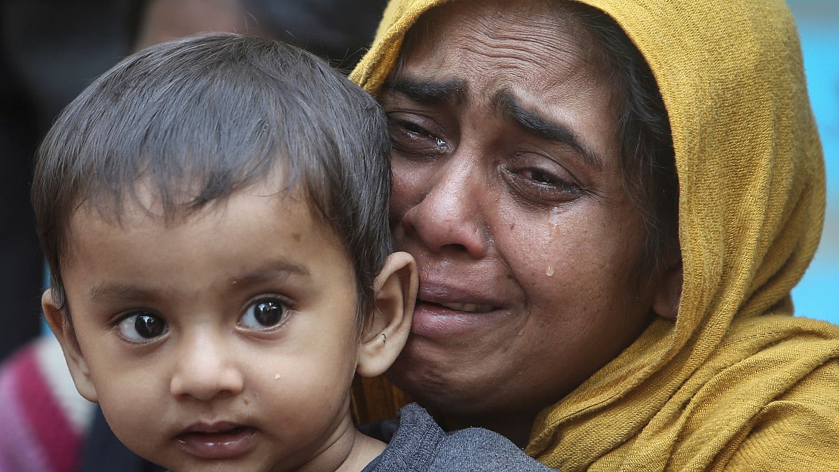 FILE PHOTO: A Rohingya Muslim woman cries as she holds her daughter after they were detained by Border Security Force (BSF) soldiers while crossing the India-Bangladesh border