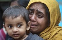 FILE PHOTO: A Rohingya Muslim woman cries as she holds her daughter after they were detained by Border Security Force (BSF) soldiers while crossing the India-Bangladesh border