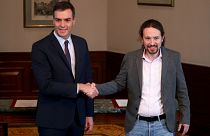 Spanish acting Prime Minister Pedro Sanchez and Unidas Podemos (Together We Can) leader Pablo Iglesias shake hands during a news conference at Spain's Parliament in Madrid
