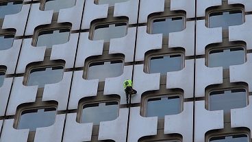 'French Spider-Man' Alain Robert scales Paris skyscraper as police watch on