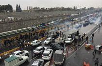 People stop their cars in a highway to show their protest for increased gas price in Tehran, Iran