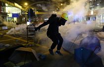 A protester runs from tear gas during clashes with riot police at Tsim Sha Tsui, in Hong Kong, China, November 18, 2019.