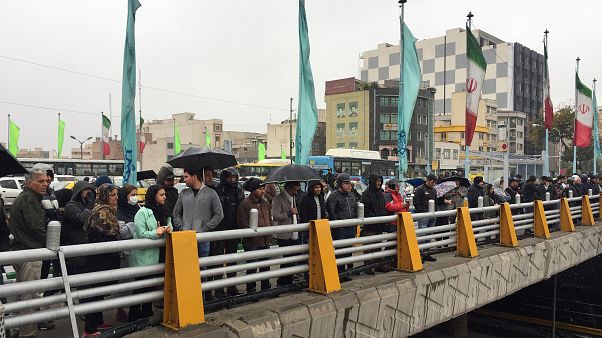 People stands in the street to show their protest against increased gas price in Tehran People stands in the street to show their protest against increased gas price in Tehran