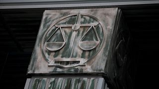 An image of scales is pictured on a pillar of the Supreme Court in Warsaw, Poland