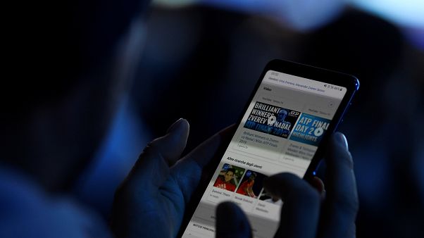 FILE PHOTO: November 13, 2019 A spectator looks at his mobile phone during Tennis - ATP Finals FILE PHOTO: November 13, 2019 A spectator looks at his mobile phone during Tennis - ATP Finals
