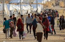 Syrian displaced families, who fled violence after the Turkish offensive in Syria, are seen upon arrival at a refugee camp in Bardarash on the outskirts of Dohuk, Iraq October