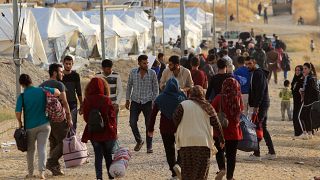 Syrian displaced families, who fled violence after the Turkish offensive in Syria, are seen upon arrival at a refugee camp in Bardarash on the outskirts of Dohuk, Iraq October