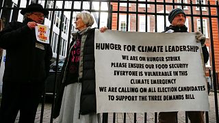 Activists affiliated with Extinction Rebellion take part in a hunger strike outside of the Conservative Party Headquarters in central London