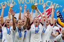 The US women's team, led by Rapinoe, celebrates winning the 2019 World Cup