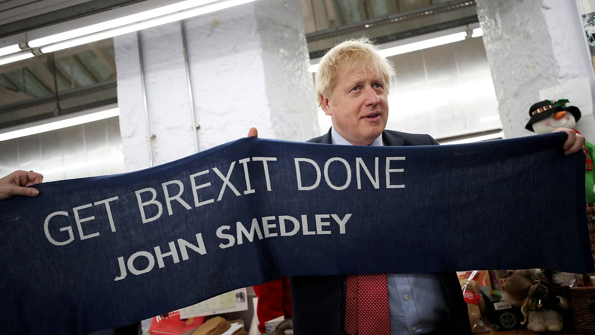 Boris Johnson posed with a knitted scarf given to him at his campaign event on Thursday