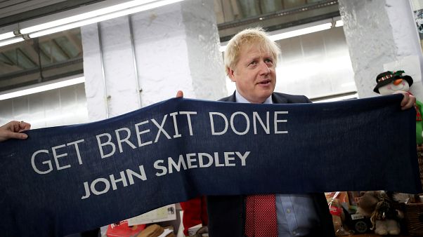 Boris Johnson posed with a knitted scarf given to him at his campaign event on Thursday Boris Johnson posed with a knitted scarf given to him at his campaign event on Thursday