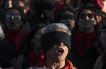 Women perform "A Rapist In Your Path," in a demonstration against gender-based violence in Santiago, Chile