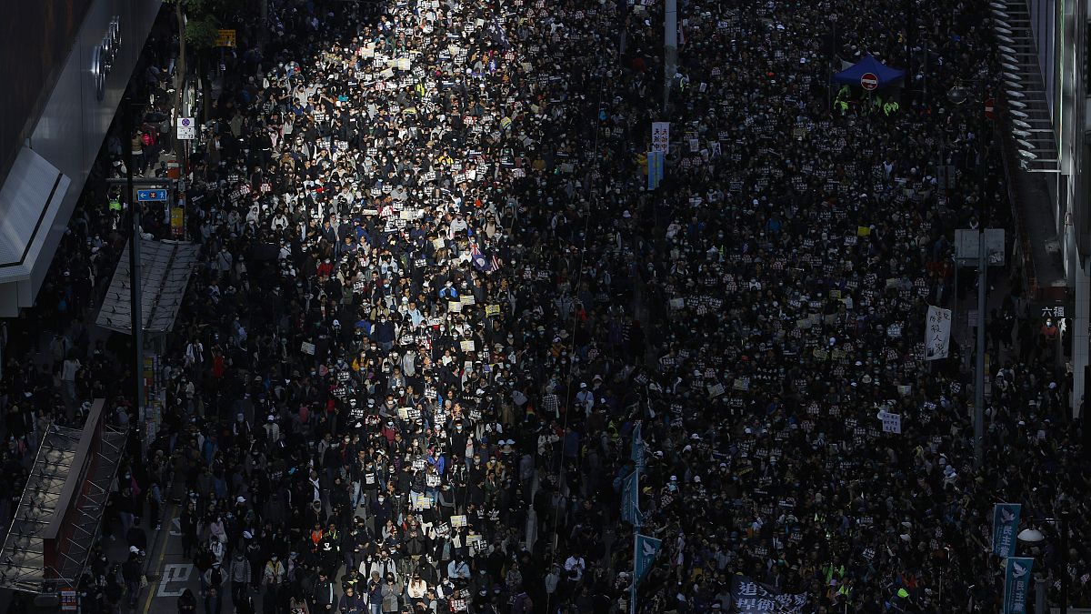 Pro-democracy protesters march on a street in Hong Kong, Sunday, Dec. 8, 2019. 