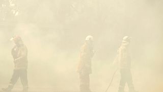 Rural Fire Service firefighters control a backburn