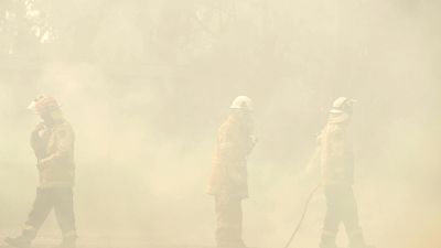 Rural Fire Service firefighters control a backburn