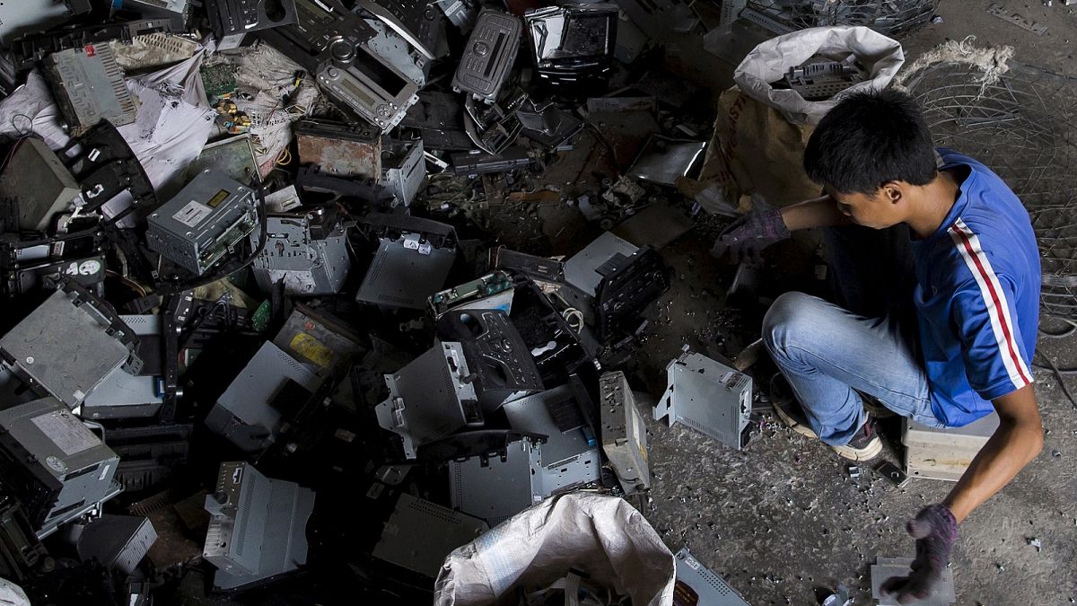 Worker recycles CD players at a workshop in the township of Guiyu in China's southern Guangdong province June 9, 2015