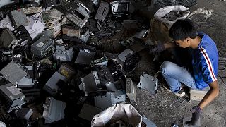 Worker recycles CD players at a workshop in the township of Guiyu in China's southern Guangdong province June 9, 2015