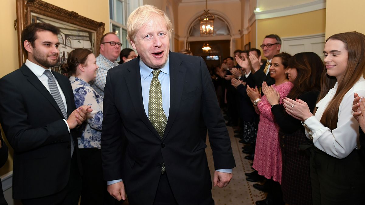 Britain's Prime Minister Boris Johnson is greeted by staff as he arrives back at Downing Street, in London, Britain December 13, 2019. 